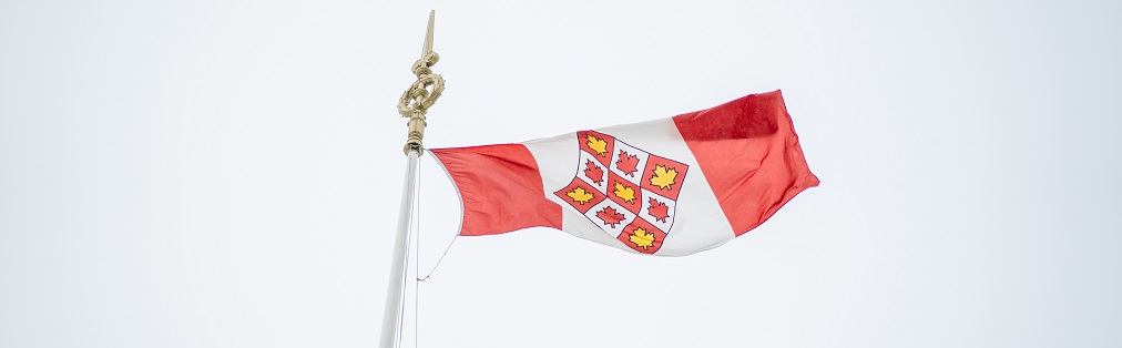 The Supreme Court of Canada flag flying against the sky