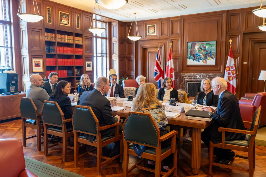 The delegations from the Supreme Court of Canada and the United Kingdom Supreme Court seated around a meeting table